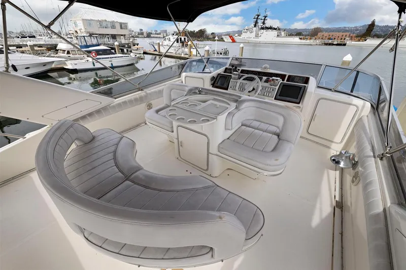  Yacht Photos Pics 1994 Sea Ray 550 Sedan Bridge yacht cockpit with luxurious seating and control panel.