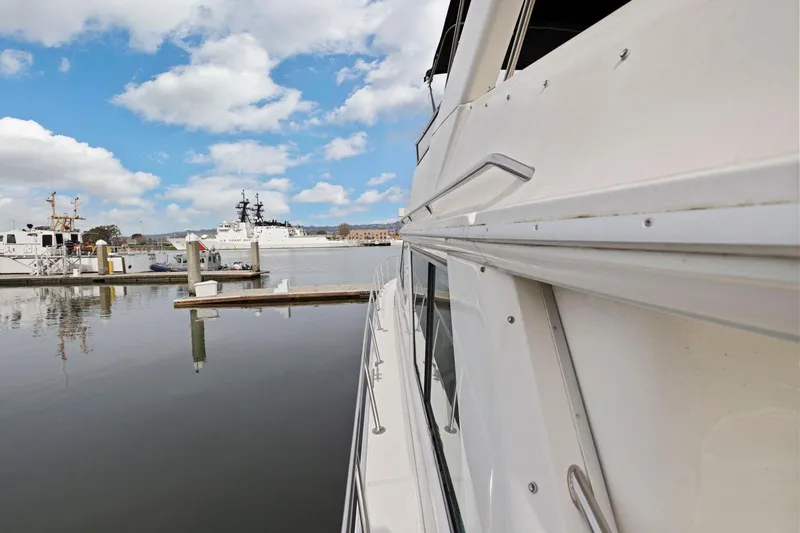  Yacht Photos Pics Side view of a 1994 Sea Ray 550 Sedan Bridge yacht docked in a marina.