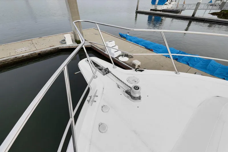  Yacht Photos Pics 1994 Sea Ray 550 Sedan Bridge yacht docked at marina, showing bow and railing.