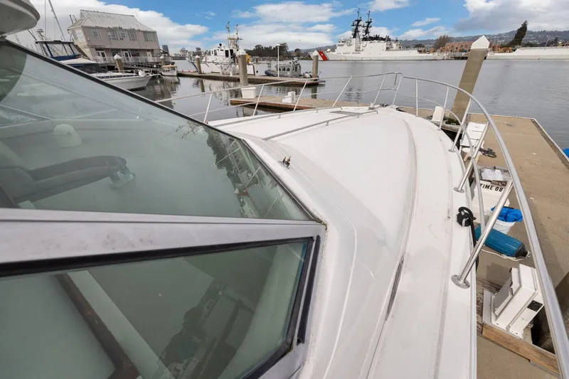  Yacht Photos Pics 1994 Sea Ray 550 Sedan Bridge yacht docked at marina, showcasing sleek design and spacious deck.