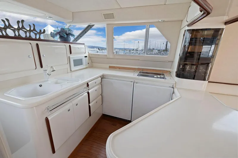  Yacht Photos Pics Luxurious kitchen interior of 1994 Sea Ray 550 Sedan Bridge yacht with modern amenities.