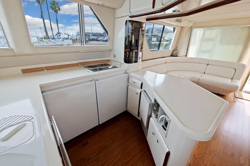  Yacht Photos Pics Luxurious interior of 1994 Sea Ray 550 Sedan Bridge yacht with modern kitchen and seating area.
