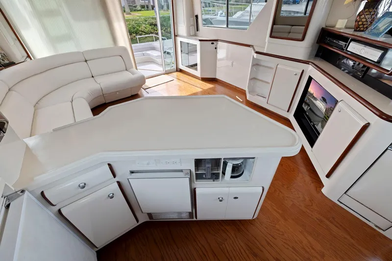  Yacht Photos Pics Luxurious interior of 1994 Sea Ray 550 Sedan Bridge yacht with modern kitchen and seating area.