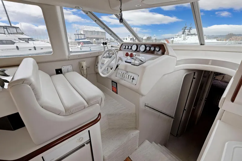  Yacht Photos Pics 1994 Sea Ray 550 Sedan Bridge helm with white leather seating and panoramic windows.