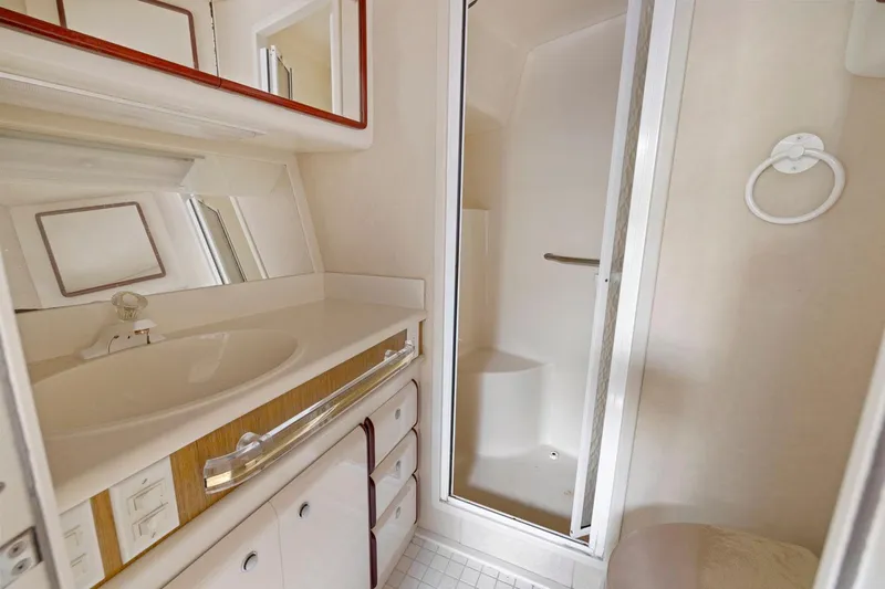  Yacht Photos Pics Bathroom interior of 1994 Sea Ray 550 Sedan Bridge yacht with shower and vanity.
