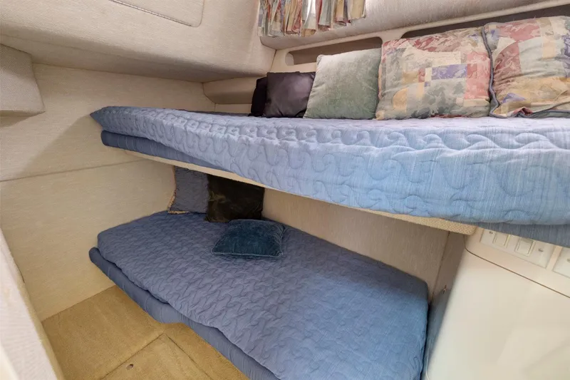  Yacht Photos Pics Interior of 1994 Sea Ray 550 Sedan Bridge with cozy bunk beds and cushions.