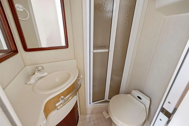  Yacht Photos Pics Bathroom interior of 1994 Sea Ray 550 Sedan Bridge with shower, sink, and toilet.