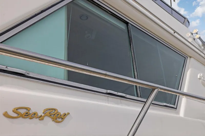  Yacht Photos Pics Close-up of 1994 Sea Ray 550 Sedan Bridge yacht window and logo.