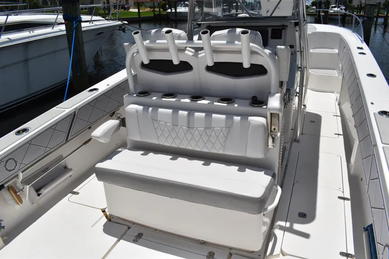 Harry's Dream Yacht Photos Pics 2005 Fountain 38 Sportfish CC Tournament boat interior with white seating and rod holders.