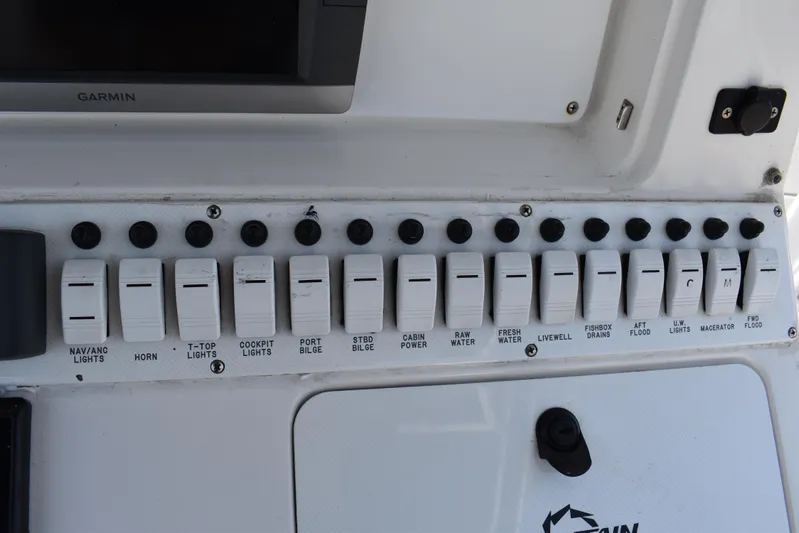 Harry's Dream Yacht Photos Pics Control panel of a 2005 Fountain 38 Sportfish CC Tournament boat with labeled switches.