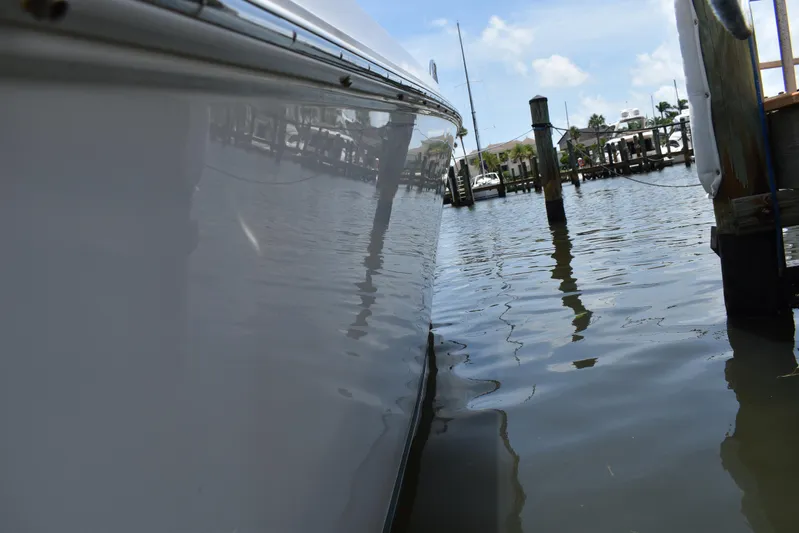 Harry's Dream Yacht Photos Pics Side view of a 2005 Fountain 38 Sportfish CC Tournament boat docked in calm waters.