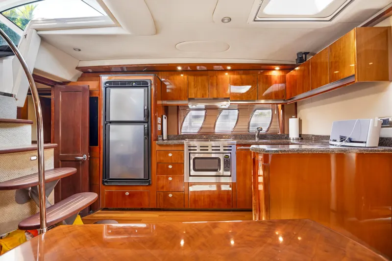 United Yacht Photos Pics Luxurious 2007 Sea Ray 480 Sundancer yacht interior with modern kitchen and wooden cabinetry.
