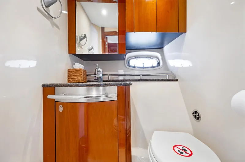 United Yacht Photos Pics Luxurious bathroom in 2007 Sea Ray 480 Sundancer yacht with wooden cabinetry.