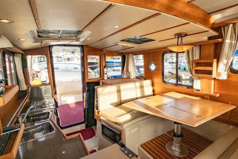 R & R Yacht Photos Pics 2019 Ranger Tugs R-31-S interior with dining area, kitchenette, and large windows.