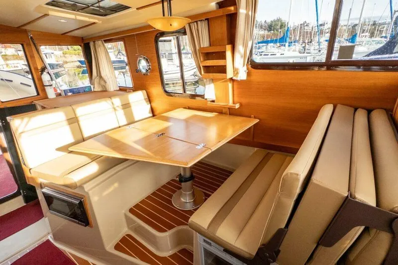 R & R Yacht Photos Pics Interior of 2019 Ranger Tugs R-31-S with dining area and wooden accents.