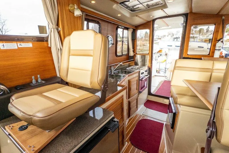 R & R Yacht Photos Pics 2019 Ranger Tugs R-31-S interior with beige seating, kitchenette, and wooden accents.