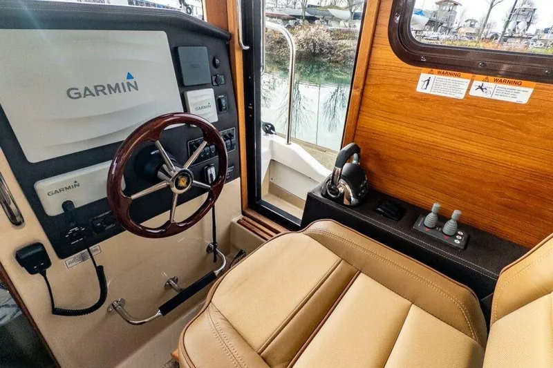 R & R Yacht Photos Pics 2019 Ranger Tugs R-31-S helm with Garmin navigation system and leather seating.