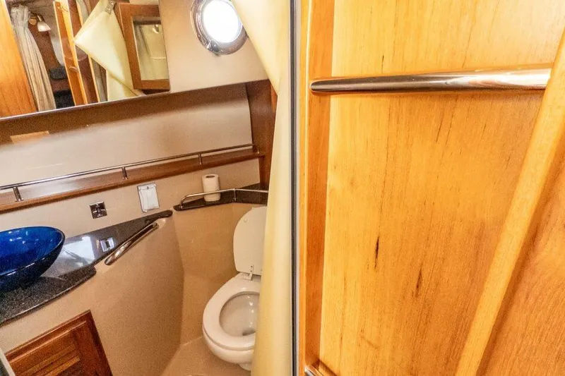 R & R Yacht Photos Pics 2019 Ranger Tugs R-31-S bathroom with wooden accents and modern fixtures.