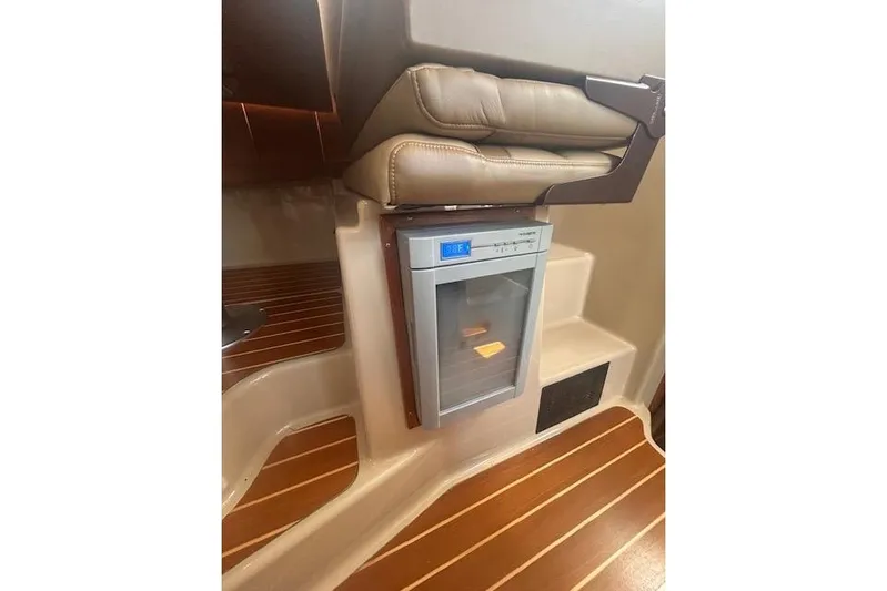 R & R Yacht Photos Pics 2019 Ranger Tugs R-31-S interior with compact fridge and wooden flooring.