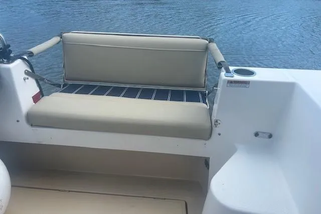 R & R Yacht Photos Pics 2019 Ranger Tugs R-31-S boat with beige seating, cup holder, and water view.