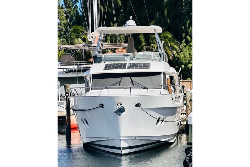 Electric Summer Yacht Photos Pics 2024 Greenline 48 Fly Hybrid yacht docked, featuring sleek design and solar panels.