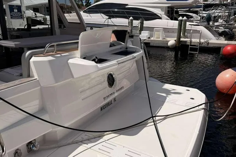 Electric Summer Yacht Photos Pics 2024 Greenline 48 Fly Hybrid yacht docked at marina, rear view.