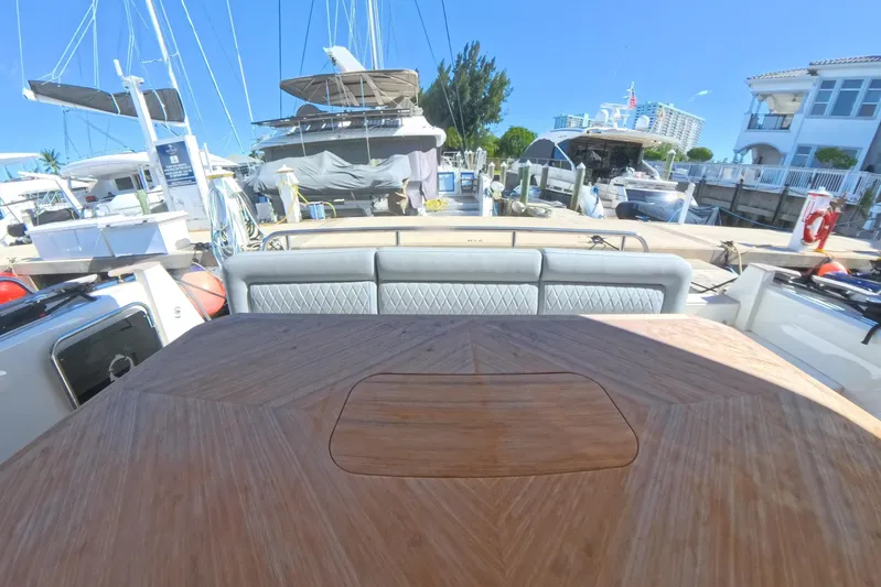 Electric Summer Yacht Photos Pics 2024 Greenline 48 Fly Hybrid yacht interior with wooden table and marina view.