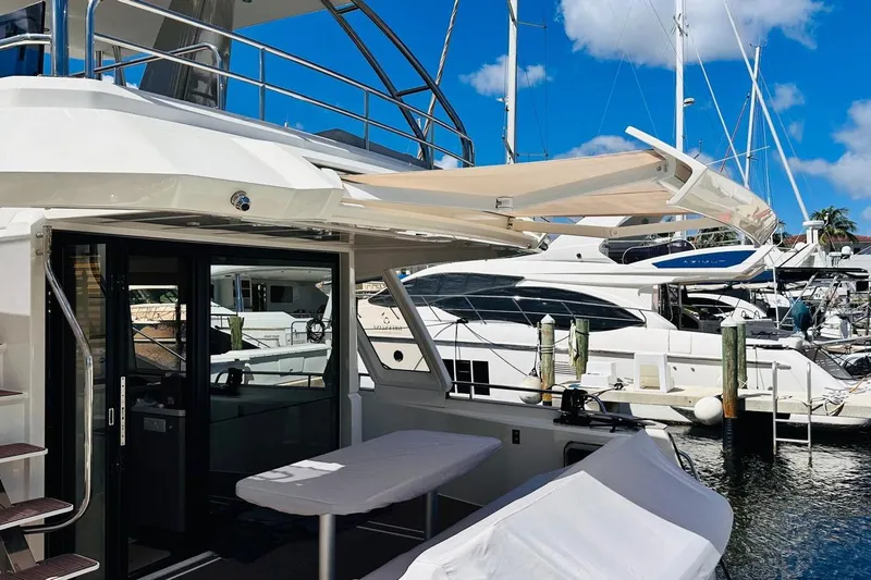 Electric Summer Yacht Photos Pics 2024 Greenline 48 Fly Hybrid yacht docked at marina, showcasing sleek design and modern features.