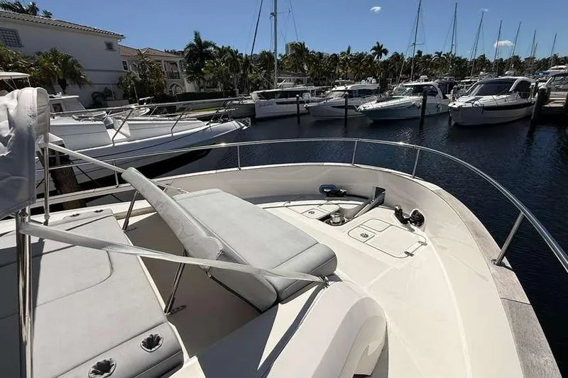 Electric Summer Yacht Photos Pics 2024 Greenline 48 Fly Hybrid yacht docked in a marina, surrounded by other boats.