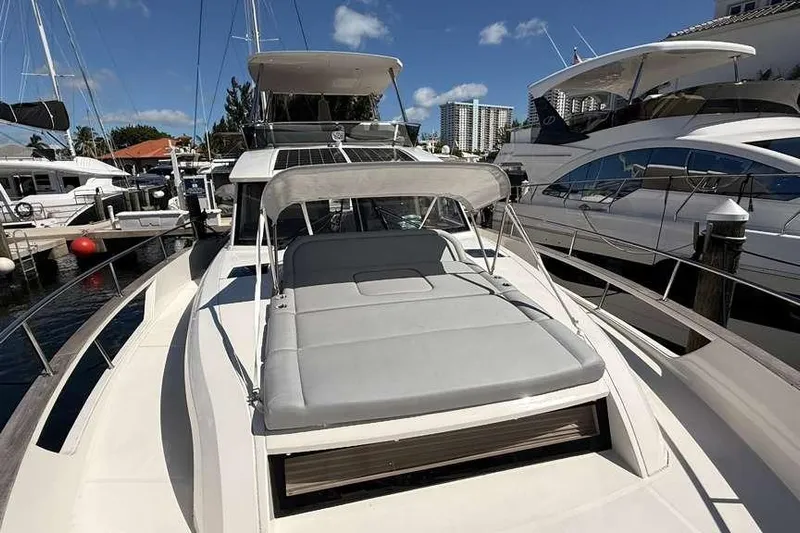 Electric Summer Yacht Photos Pics 2024 Greenline 48 Fly Hybrid yacht docked, featuring spacious sunbathing area and sleek design.