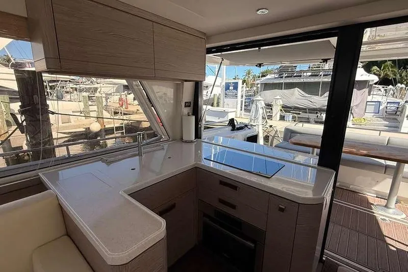 Electric Summer Yacht Photos Pics Interior of 2024 Greenline 48 Fly Hybrid yacht, featuring modern kitchen and outdoor seating.