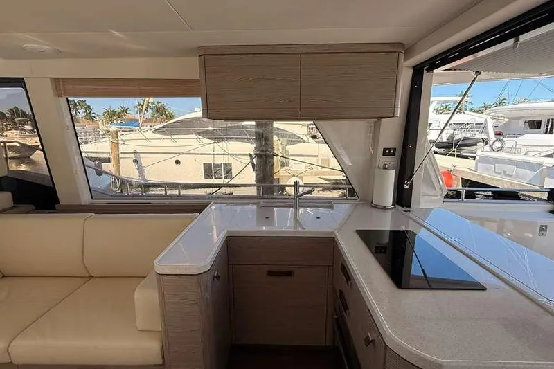 Electric Summer Yacht Photos Pics Interior of 2024 Greenline 48 Fly Hybrid yacht with modern kitchen and marina view.