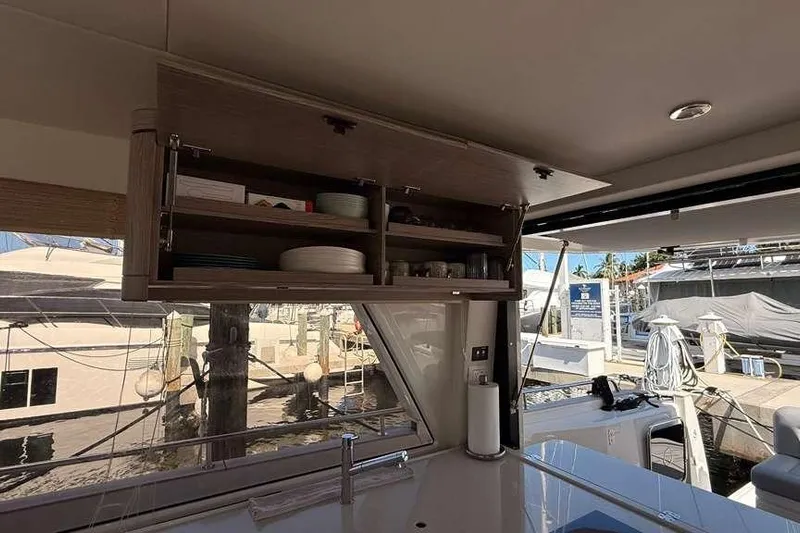 Electric Summer Yacht Photos Pics Interior of 2024 Greenline 48 Fly Hybrid yacht with open kitchen cabinet.