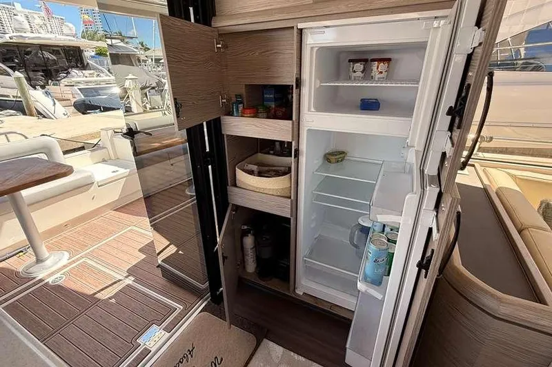 Electric Summer Yacht Photos Pics 2024 Greenline 48 Fly Hybrid yacht interior with open fridge and storage cabinets.