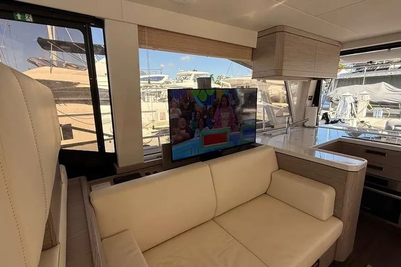 Electric Summer Yacht Photos Pics Luxurious interior of 2024 Greenline 48 Fly Hybrid yacht with TV and modern furnishings.