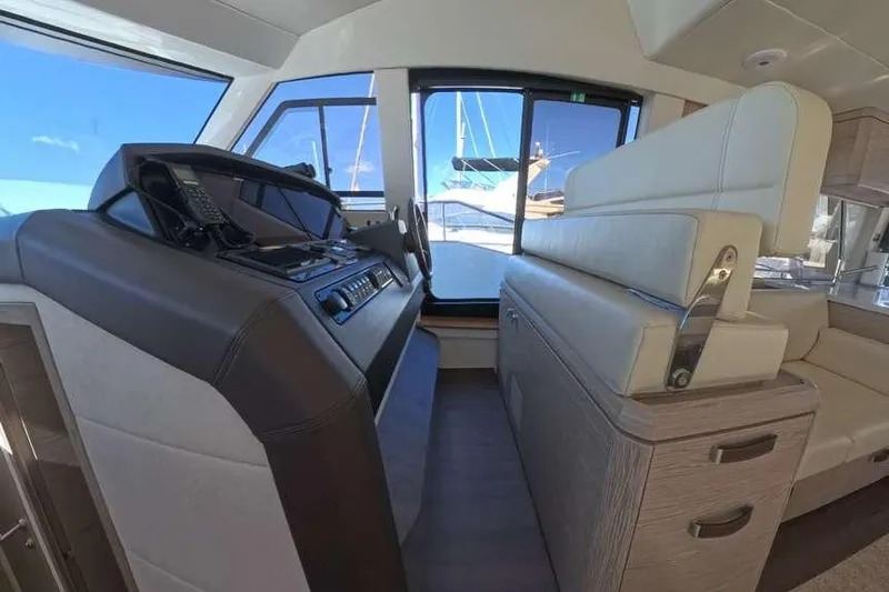 Electric Summer Yacht Photos Pics 2024 Greenline 48 Fly Hybrid yacht interior with helm station and seating area.