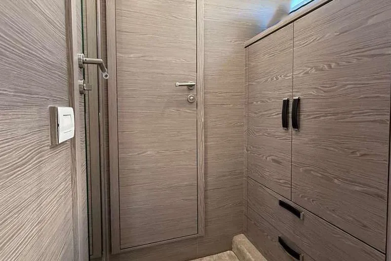 Electric Summer Yacht Photos Pics Interior of 2024 Greenline 48 Fly Hybrid yacht with wood finish and storage cabinets.