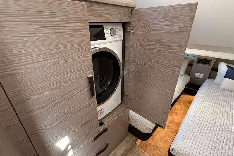 Electric Summer Yacht Photos Pics 2024 Greenline 48 Fly Hybrid interior with washer in wooden cabinet, adjacent to twin beds.