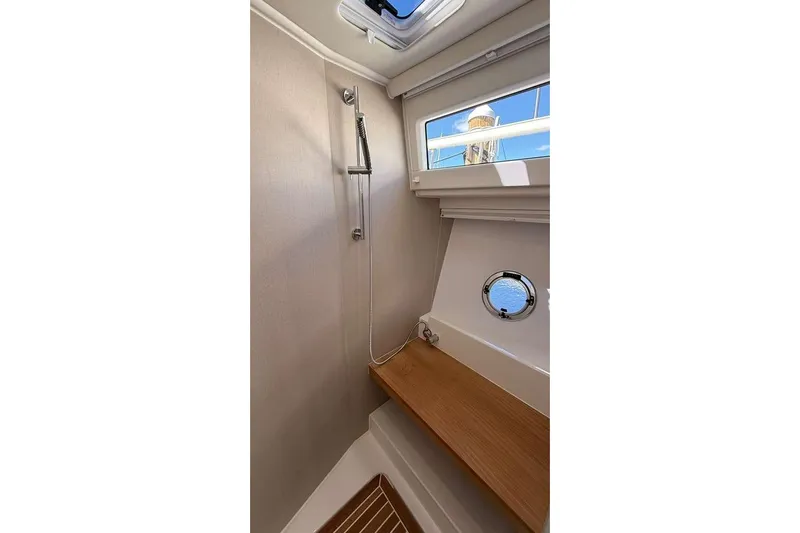Electric Summer Yacht Photos Pics 2024 Greenline 48 Fly Hybrid yacht shower with wooden bench and porthole window.