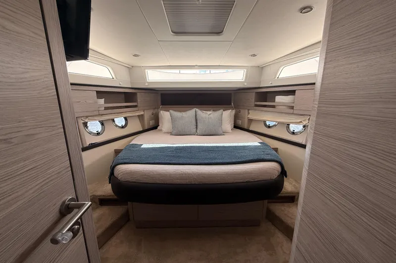 Electric Summer Yacht Photos Pics Luxurious cabin interior of 2024 Greenline 48 Fly Hybrid yacht, featuring a cozy bed and elegant design.