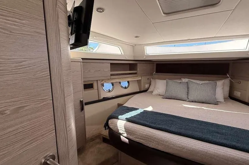 Electric Summer Yacht Photos Pics Luxurious cabin interior of 2024 Greenline 48 Fly Hybrid yacht with cozy bed and modern design.