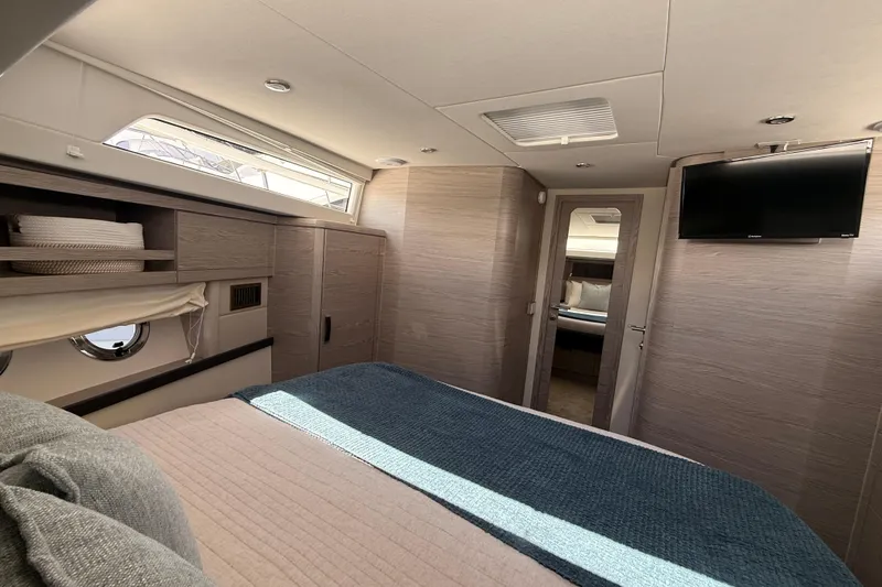 Electric Summer Yacht Photos Pics Luxurious interior of 2024 Greenline 48 Fly Hybrid yacht bedroom with modern amenities.