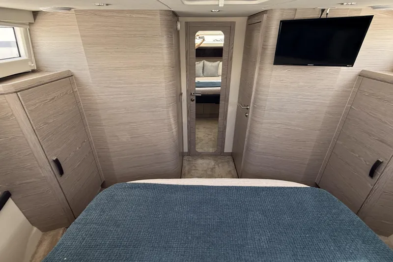 Electric Summer Yacht Photos Pics Luxurious interior of 2024 Greenline 48 Fly Hybrid yacht with modern furnishings and TV.