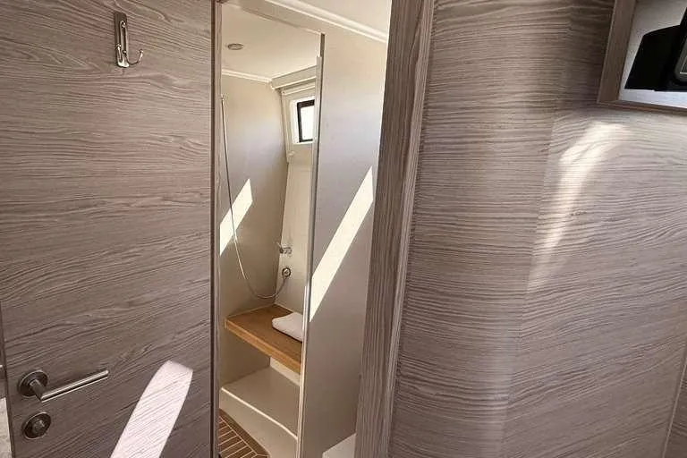 Electric Summer Yacht Photos Pics 2024 Greenline 48 Fly Hybrid yacht bathroom with modern wood finish and natural lighting.