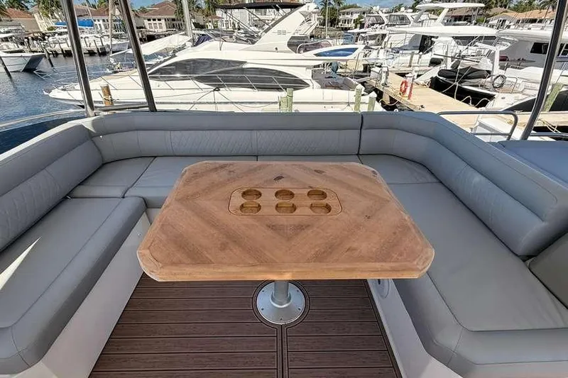 Electric Summer Yacht Photos Pics Luxurious seating area on 2024 Greenline 48 Fly Hybrid yacht with wooden table.