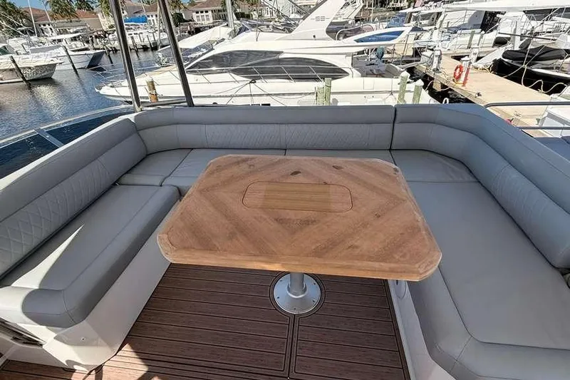 Electric Summer Yacht Photos Pics Luxury seating area on 2024 Greenline 48 Fly Hybrid yacht, featuring elegant wood table.