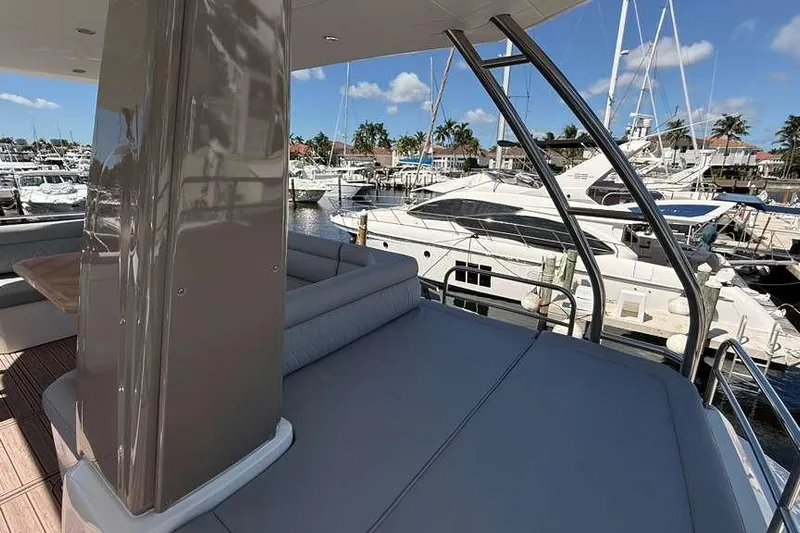 Electric Summer Yacht Photos Pics 2024 Greenline 48 Fly Hybrid yacht at marina, showcasing luxurious deck and seating area.