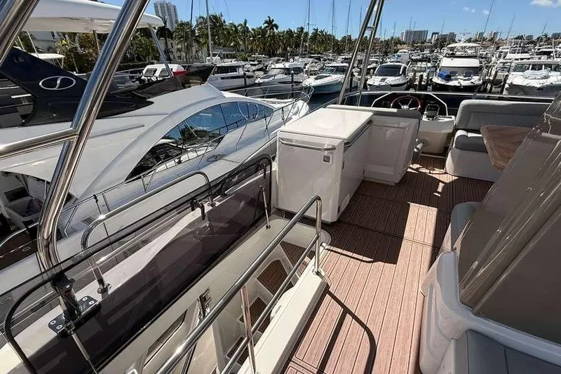 Electric Summer Yacht Photos Pics 2024 Greenline 48 Fly Hybrid yacht interior with marina view, showcasing luxury and modern design.