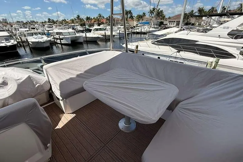 Electric Summer Yacht Photos Pics Outdoor seating area on 2024 Greenline 48 Fly Hybrid yacht, docked at marina.