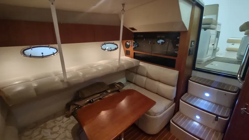  Yacht Photos Pics Interior of 2000 Tiara Yachts 3500 Open, featuring cozy seating and wooden table.